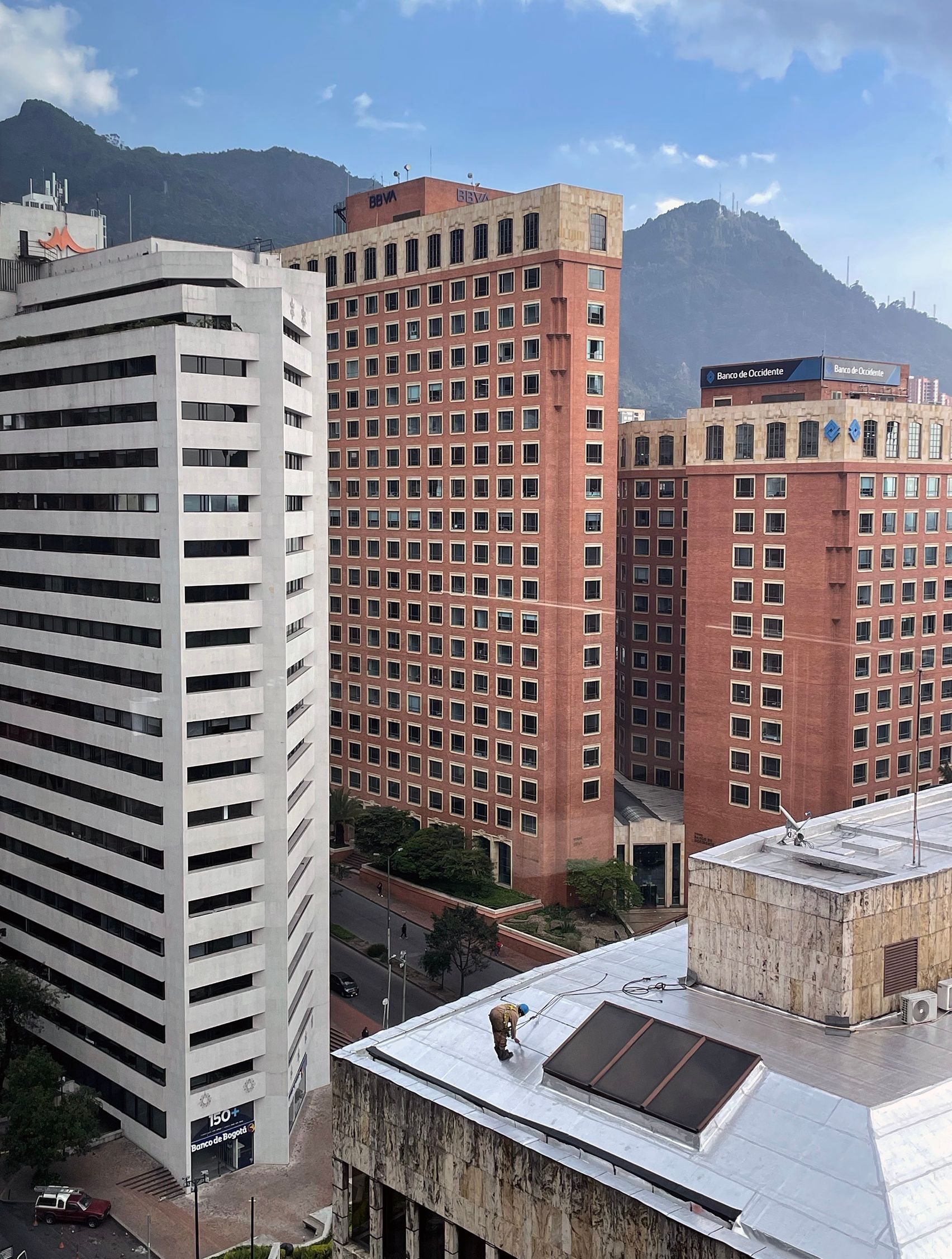 Man cleaning roof in front of the Andes
