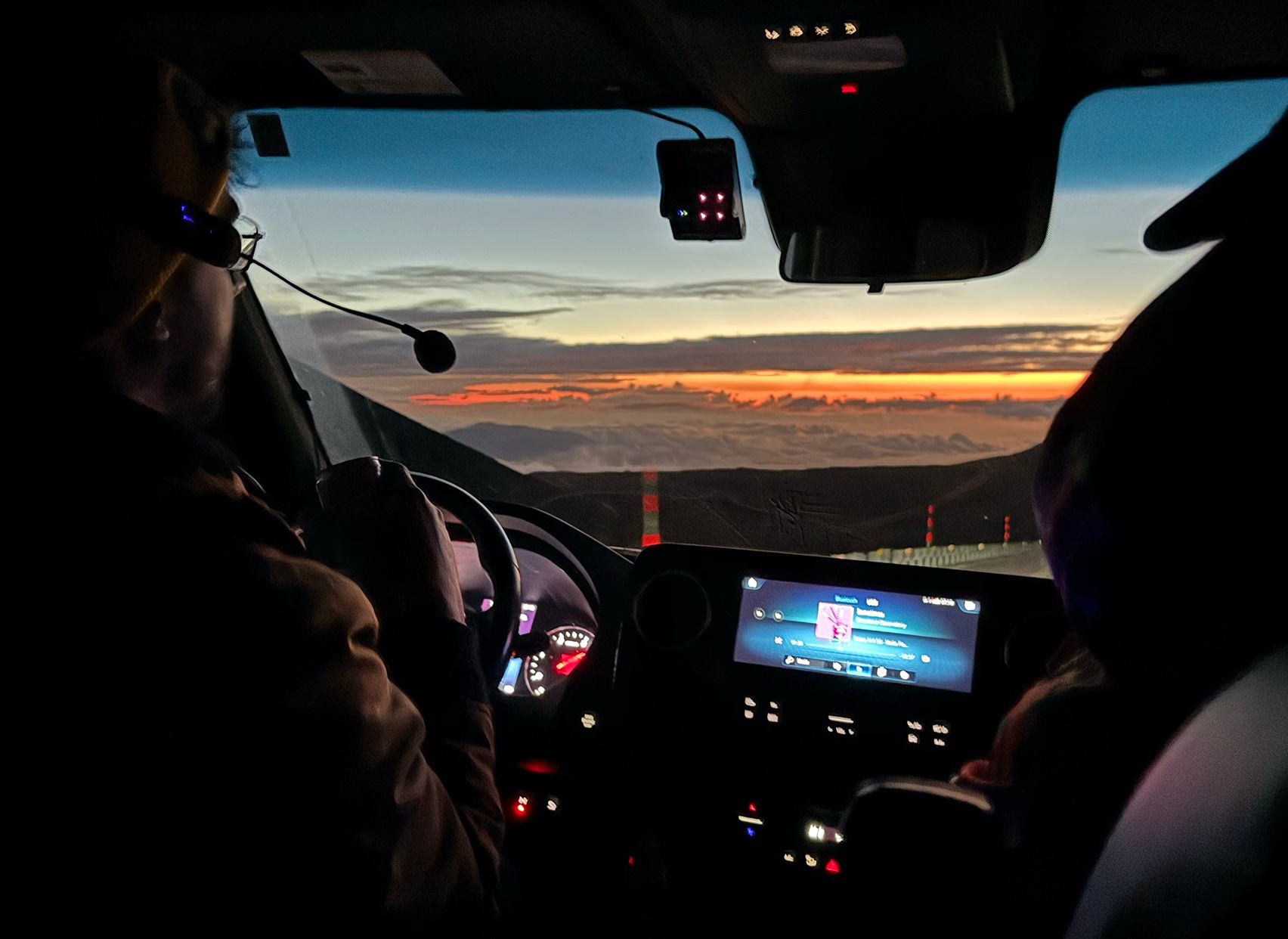 Dribing down Mauna Kea at sunset, view through windshield